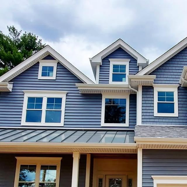 Blue-sided home with a finished roofline and gutter system