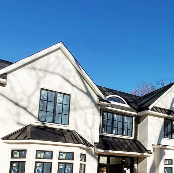 White home with dark roof details and gutter lines